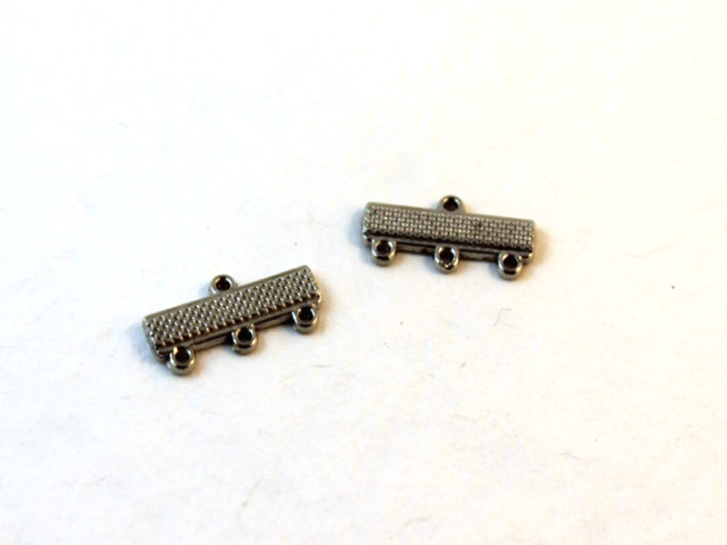 Two silver colored charm connectors