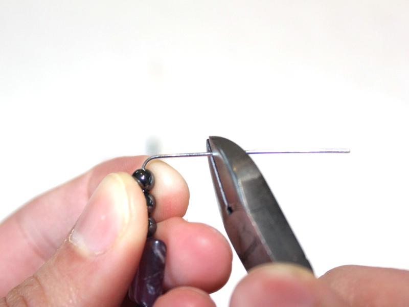 Trimming the head pins using cutting pliers.