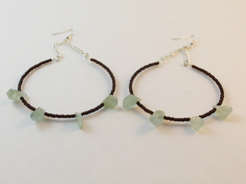 The completed hoop earrings made using pieces of memory wire, beads and silver chain.