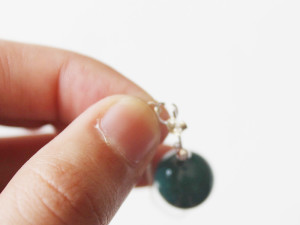 attaching the silver chain to the butterfly back of the earring using a jump ring