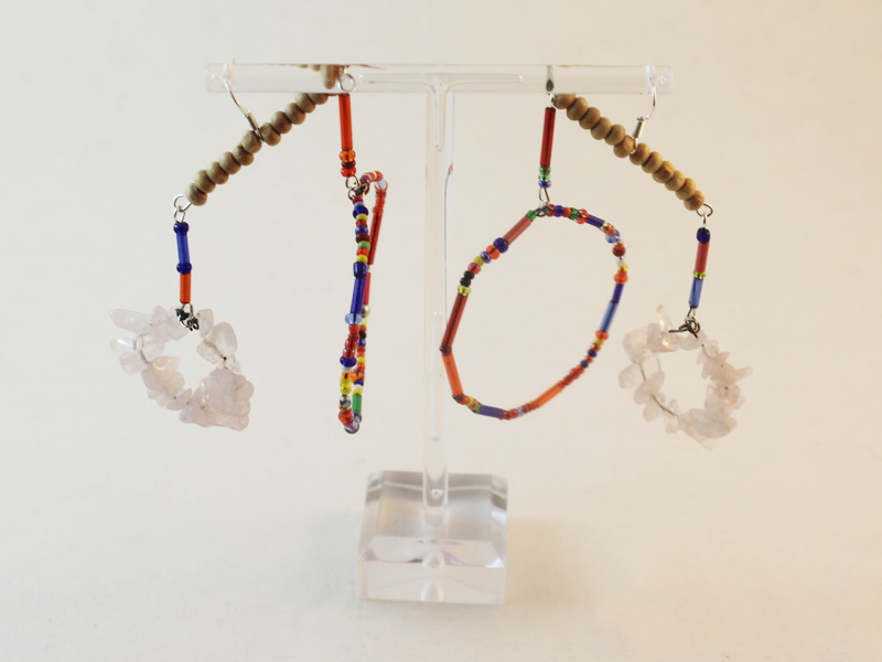the finished chandelier earrings on a stand