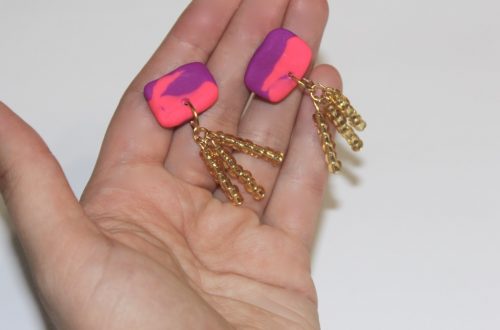 holding the finished polymer clay tassel earrings