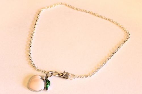 the completed anklet with a peach charm