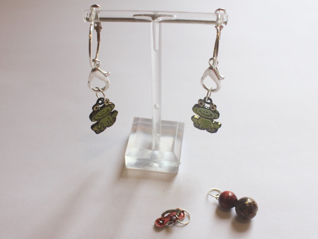 frog charms attached to hoops with other charms to the side