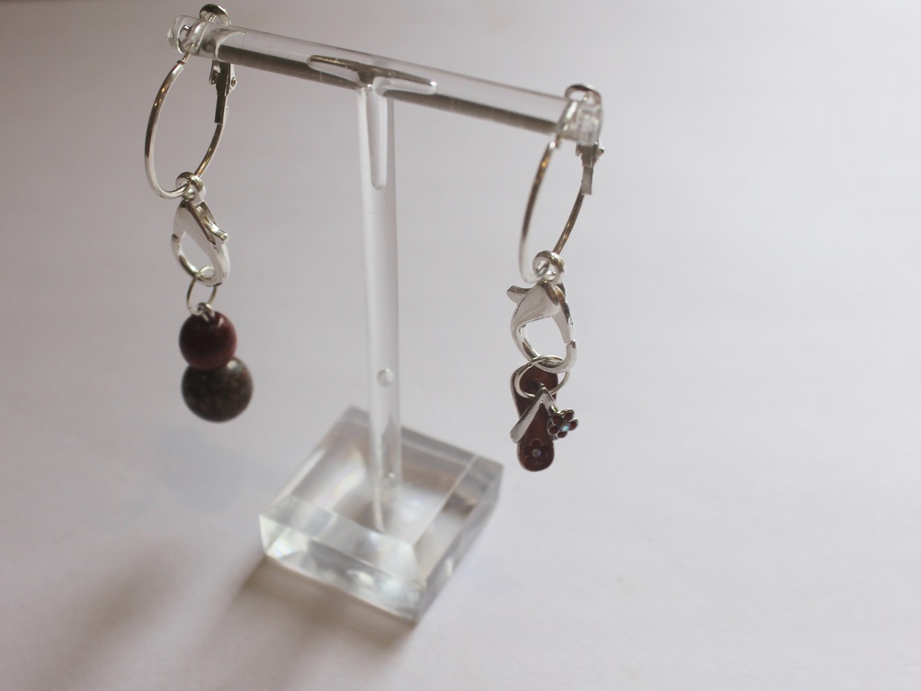 thong and bead charms attached to hoop earrings