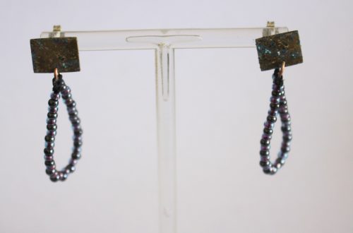 finished earrings on an earring stand front view