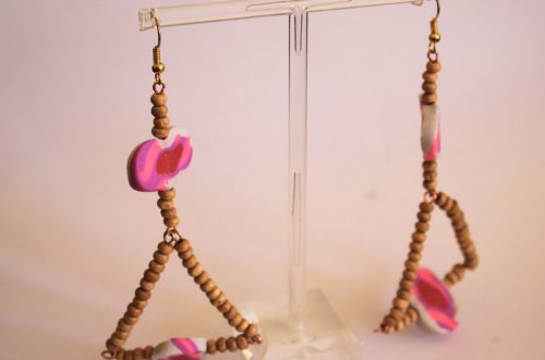 finished statement earrings with triangle detail on an earring stand