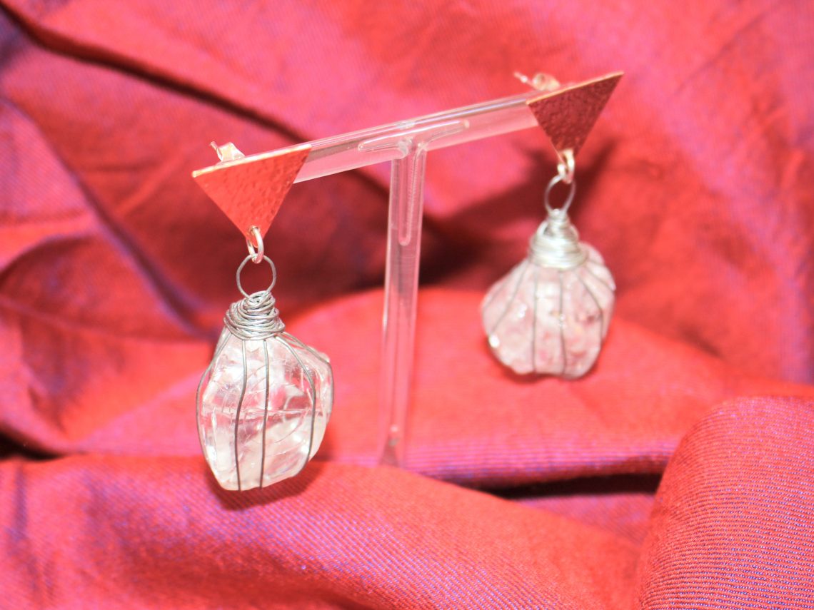 finished earrings with stud earrings in place in front of a red backdrop