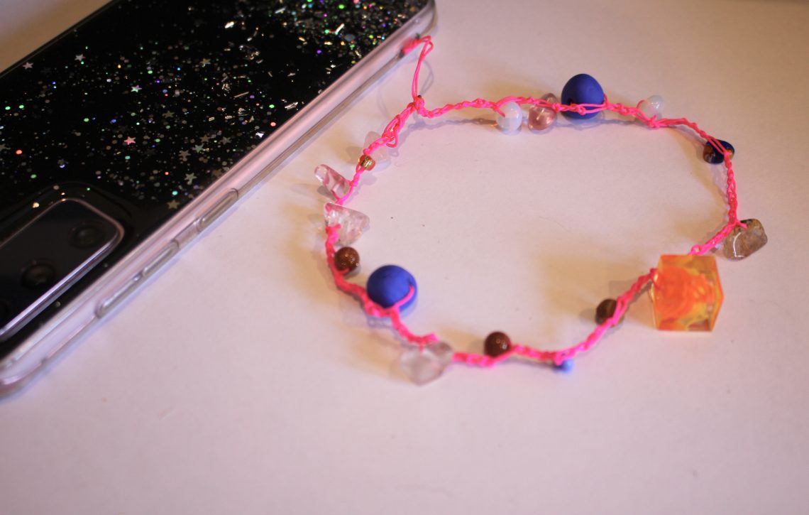 beaded crochet phone strap attached to a phone