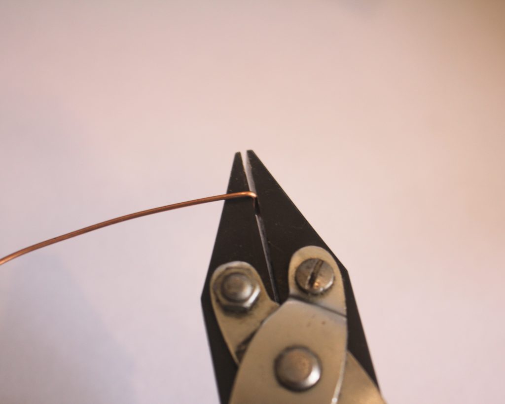 bending the end of the wire with flat nose pliers