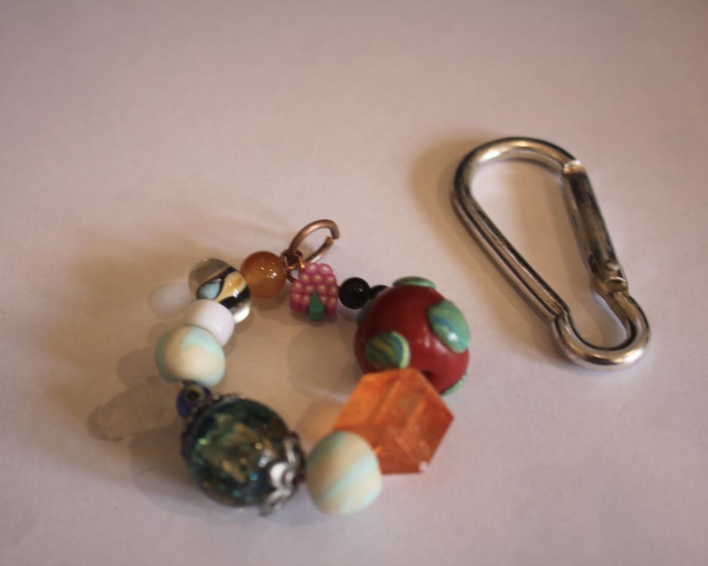 adding the second jump ring to the top of the charm